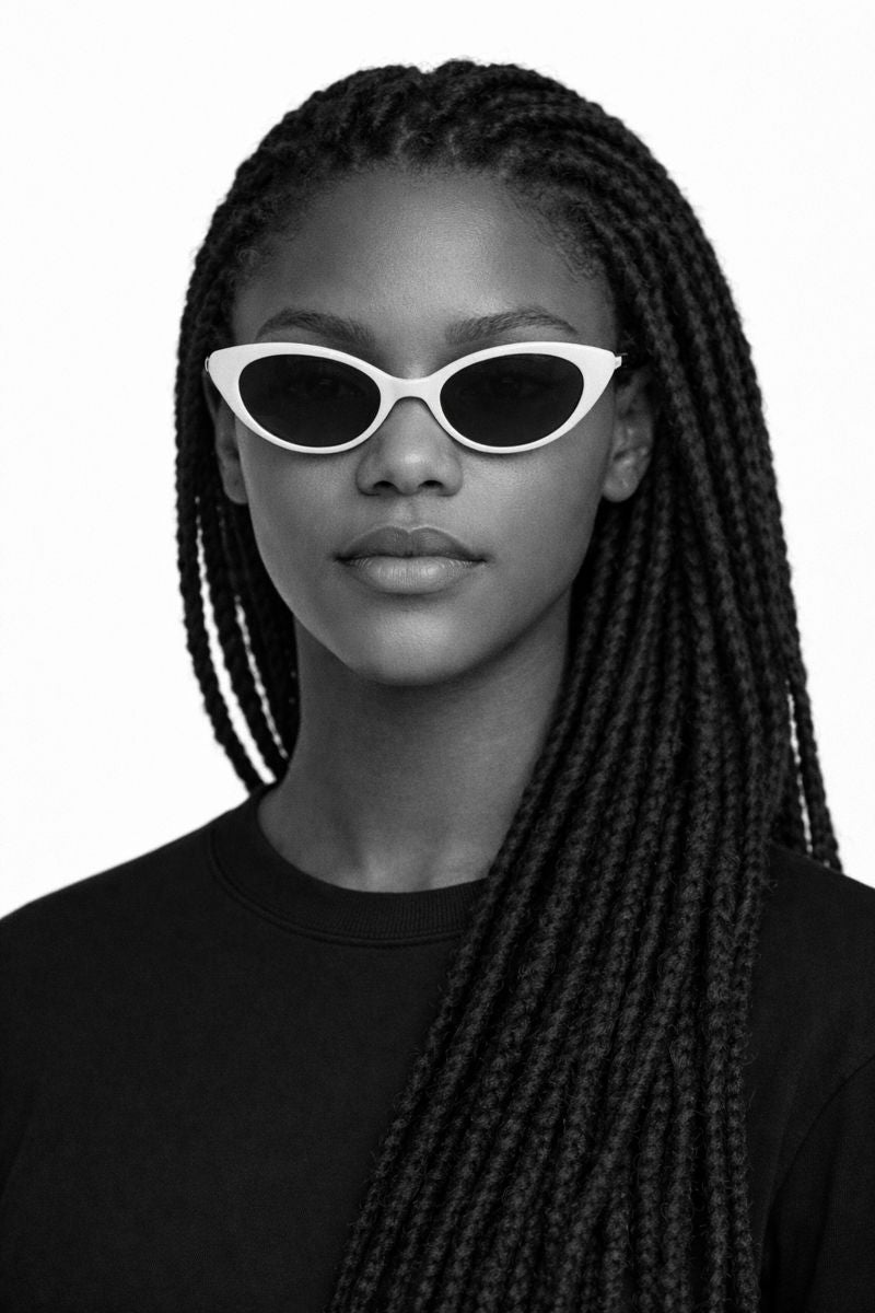 Person wearing white sunglasses with a plain background