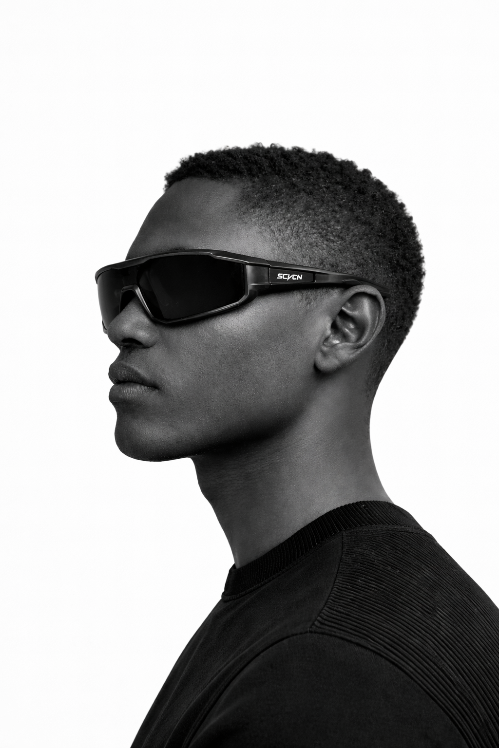 Person wearing black sunglasses with a brand logo on a white background