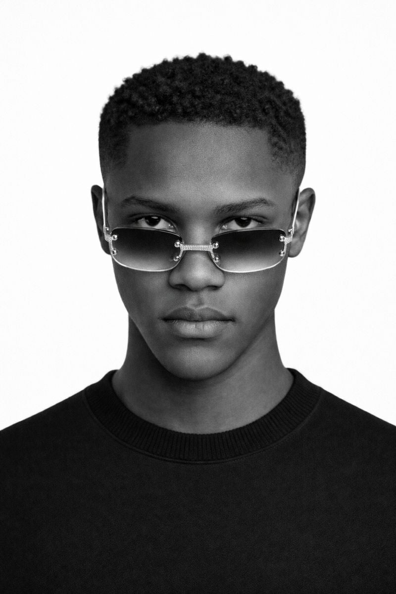 Person wearing futuristic sunglasses with a plain background