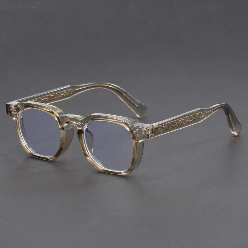 Eyeglasses with gold frame and clear lenses on a gray background